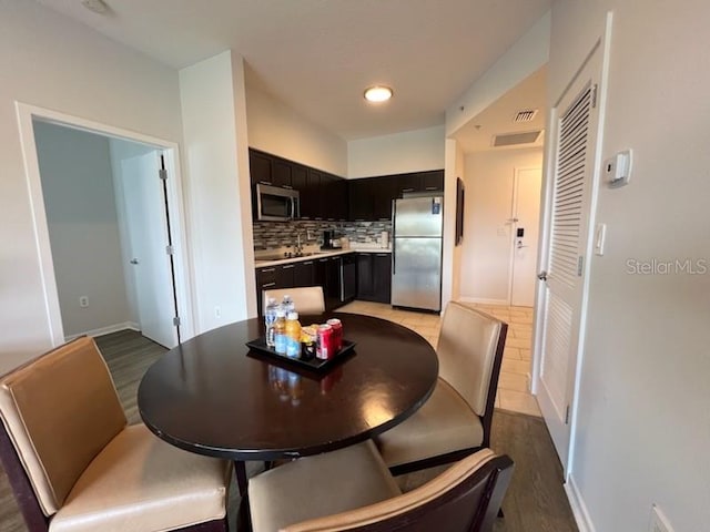 dining space with light hardwood / wood-style floors