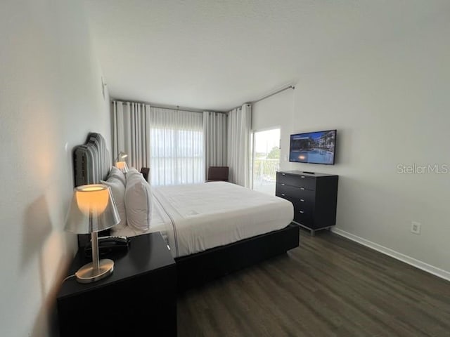 bedroom with dark wood-type flooring