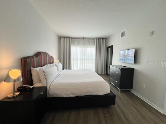 bedroom featuring dark hardwood / wood-style flooring