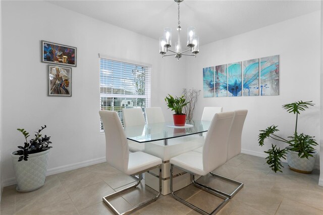 tiled dining space with a notable chandelier