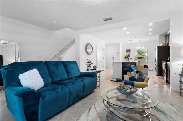 living room with light tile floors and a chandelier