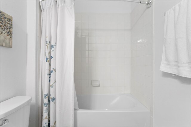 bathroom with toilet and shower / tub combo