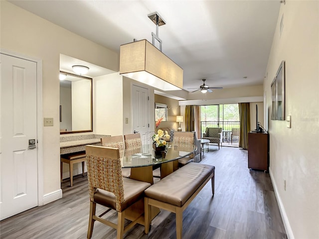 dining area with light hardwood / wood-style floors and ceiling fan