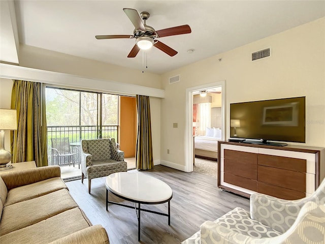 living room featuring ceiling fan and light wood-type flooring