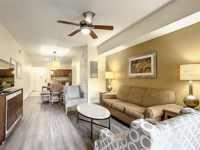 living room featuring wood-type flooring and ceiling fan