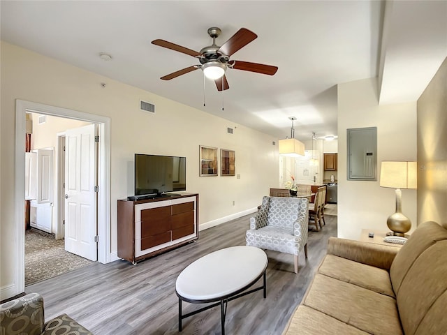 living room featuring wood-type flooring and ceiling fan