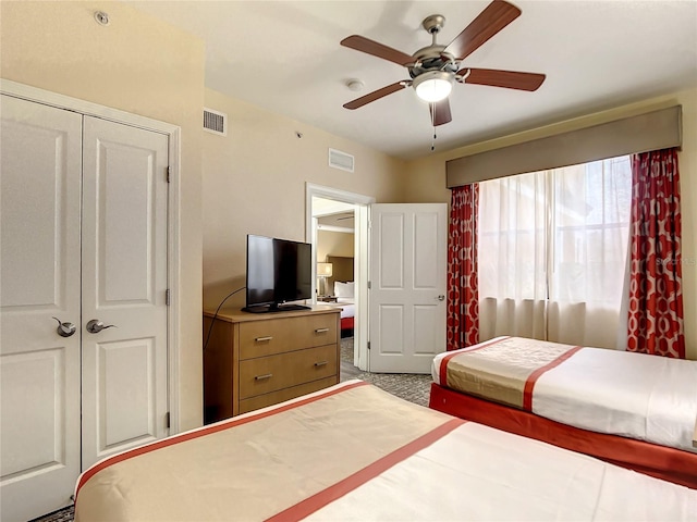 bedroom with a closet, light colored carpet, and ceiling fan