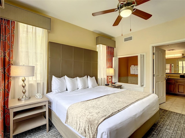 tiled bedroom featuring ceiling fan