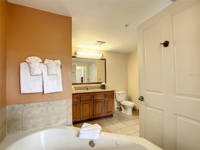 bathroom with toilet, tile flooring, a bathing tub, and oversized vanity