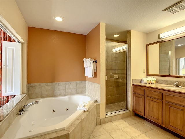 bathroom with vanity, tile flooring, and separate shower and tub