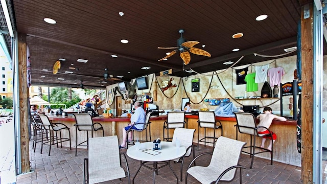 exterior space with dark tile floors, ceiling fan, and wooden ceiling