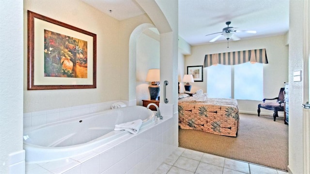 bathroom featuring a relaxing tiled bath, ceiling fan, and tile flooring