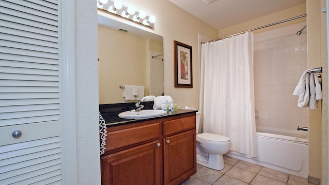 full bathroom featuring shower / tub combo, tile flooring, vanity with extensive cabinet space, and toilet