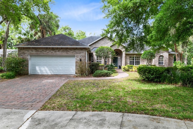 single story home with a front yard and a garage