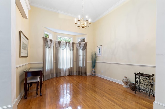 interior space featuring a chandelier, hardwood / wood-style flooring, and crown molding