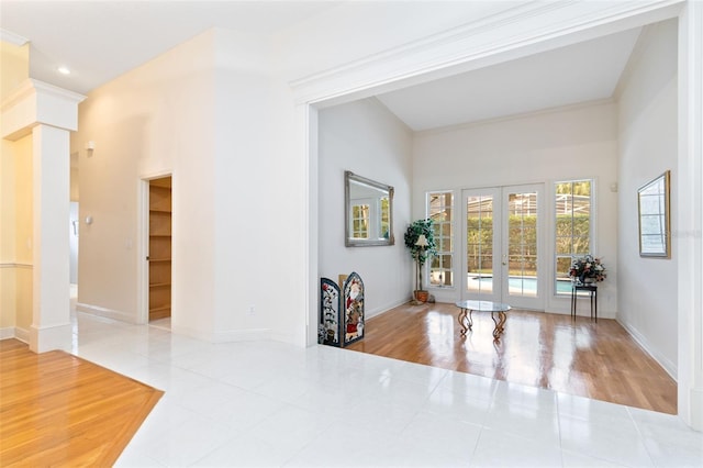 interior space featuring a high ceiling and french doors