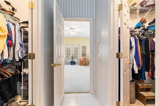 spacious closet with french doors and light tile floors