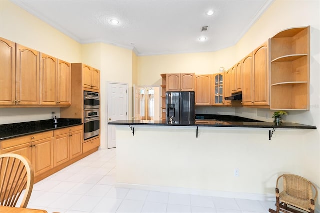 kitchen with a breakfast bar area, fridge with ice dispenser, ornamental molding, stainless steel double oven, and light tile floors