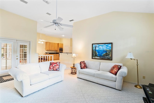 living room with light carpet, french doors, lofted ceiling, and ceiling fan