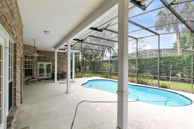 view of swimming pool featuring a lanai, a patio area, ceiling fan, and french doors