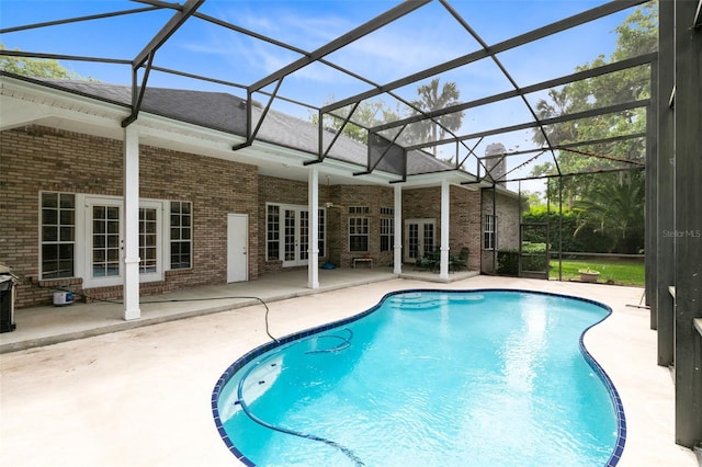 view of pool with a patio area, french doors, and glass enclosure