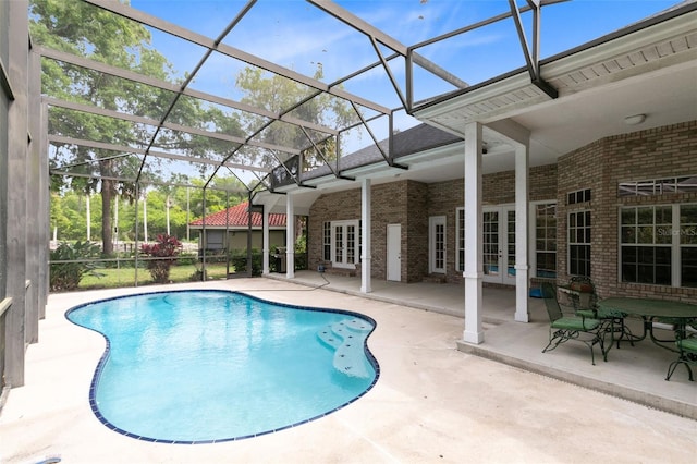 view of pool featuring french doors, a lanai, and a patio