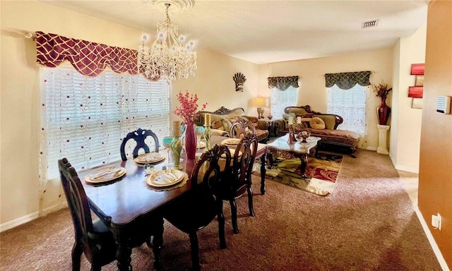 carpeted dining space with an inviting chandelier