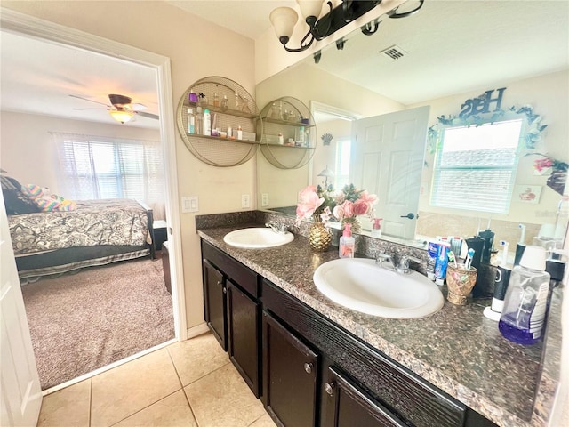 bathroom with vanity with extensive cabinet space, double sink, tile flooring, and ceiling fan