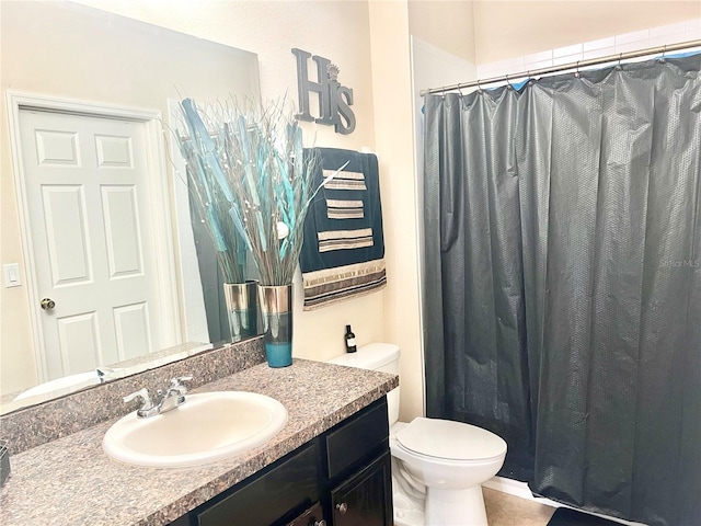 bathroom with large vanity and toilet