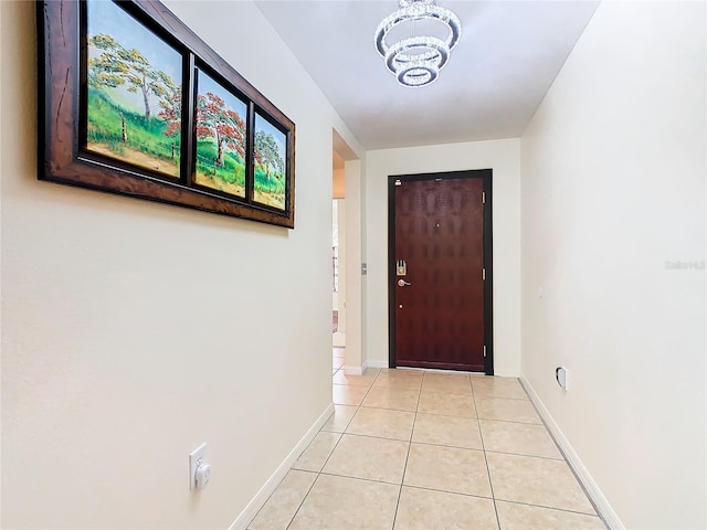 entryway featuring a notable chandelier and light tile floors