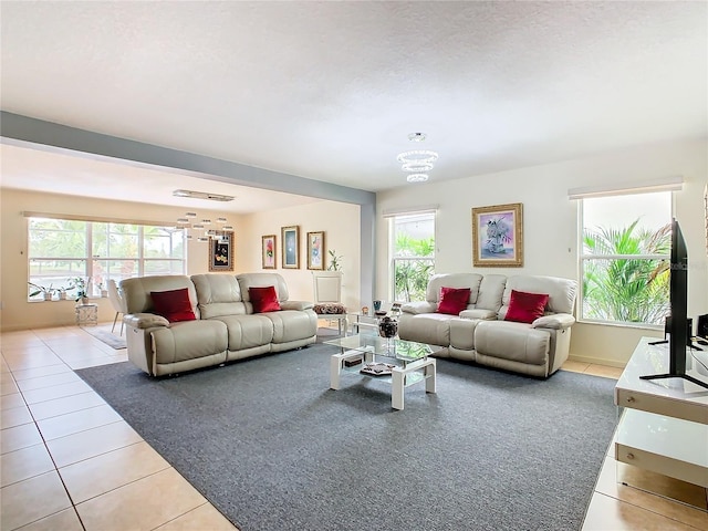 living room with a notable chandelier and light tile flooring