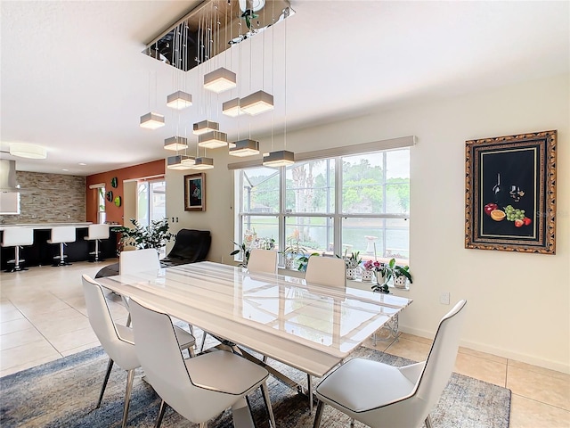 dining room featuring a healthy amount of sunlight and light tile floors