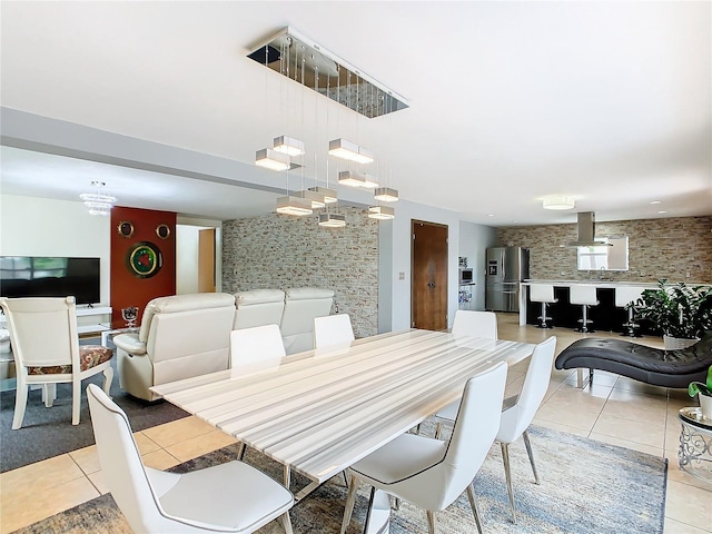 dining room with an inviting chandelier and light tile floors