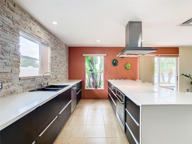 kitchen featuring appliances with stainless steel finishes, sink, a wealth of natural light, and island range hood