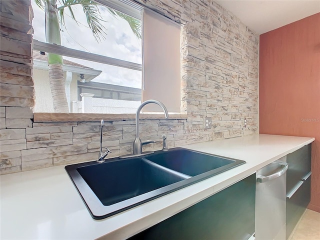 interior space featuring tasteful backsplash, dishwasher, and sink