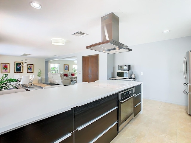 kitchen featuring island range hood, stainless steel appliances, and light tile floors