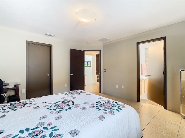 tiled bedroom featuring connected bathroom