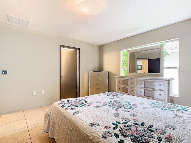 bedroom with light tile flooring