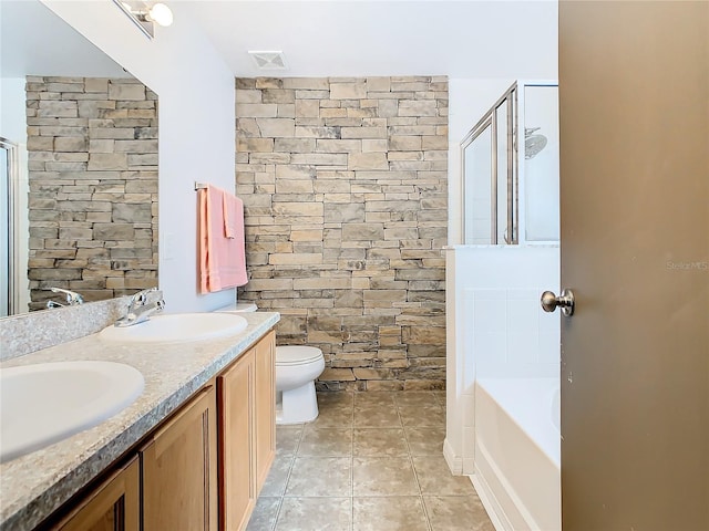 bathroom with toilet, tile floors, double sink, and large vanity