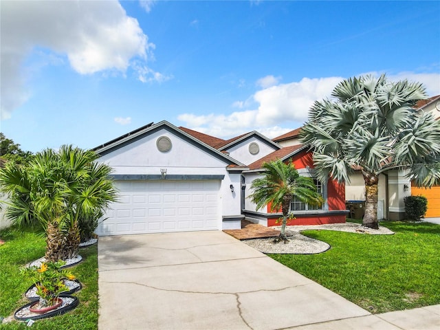 view of front of property with a front yard and a garage