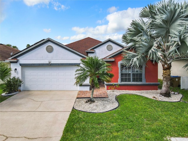 view of front of property with a front yard and a garage