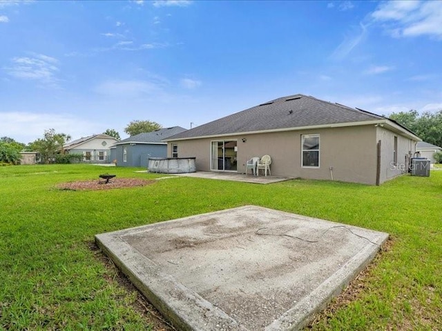 rear view of house with a lawn and a patio area