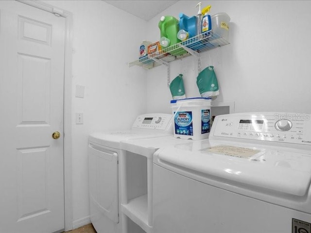 washroom with washing machine and clothes dryer