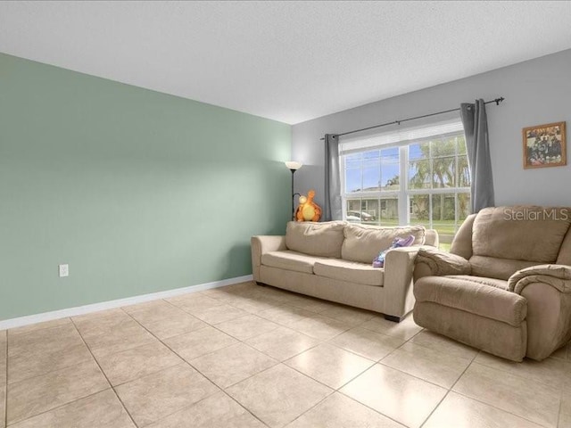 living room with a textured ceiling and light tile patterned floors