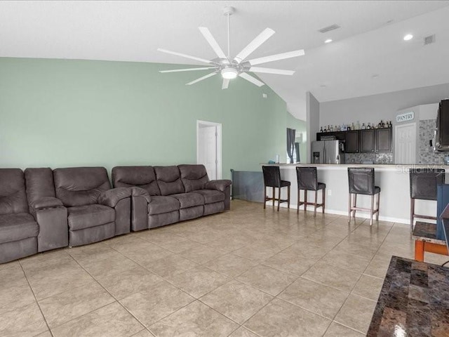 living room with high vaulted ceiling, ceiling fan, and light tile patterned floors