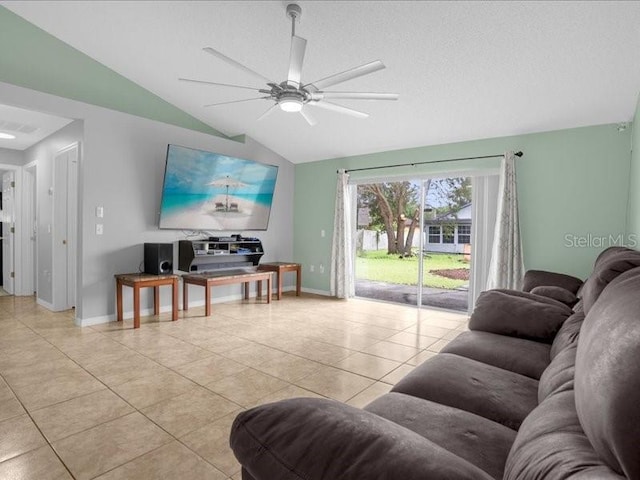 living room featuring ceiling fan, vaulted ceiling, and light tile patterned floors