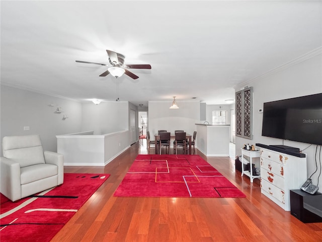 living room featuring hardwood / wood-style floors, ceiling fan, and ornamental molding