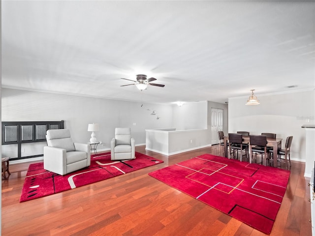 living room featuring ceiling fan, crown molding, and hardwood / wood-style floors