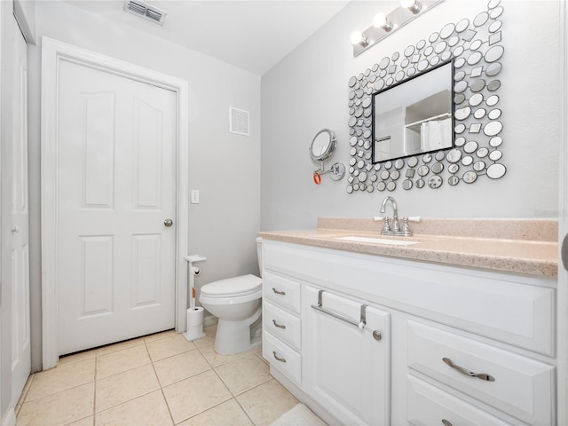 bathroom with tile patterned floors, vanity, and toilet