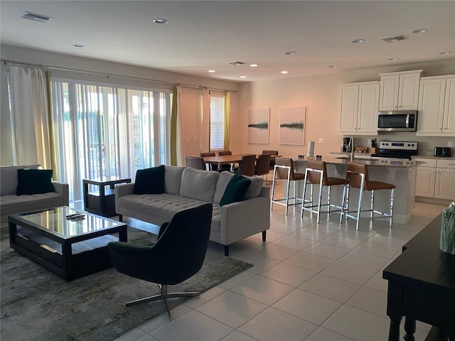 living room featuring light tile floors